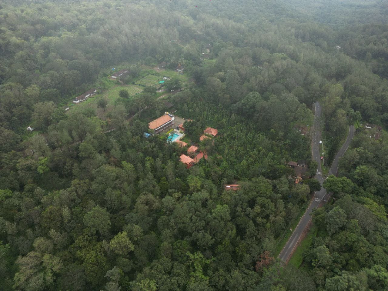 Aerial view of the stunning Blossom Resort campus nestled in Coorg greenery